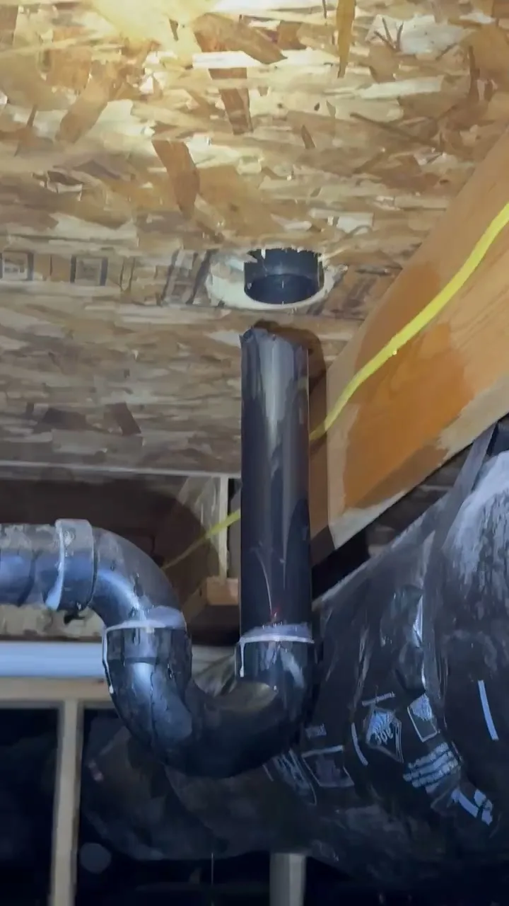 Insulated ductwork and drain piping in a crawl space