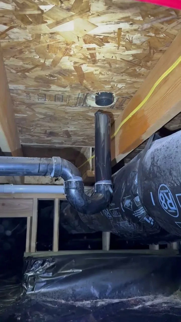 Drain line and ducting in a crawl space during an Iron Clad inspection